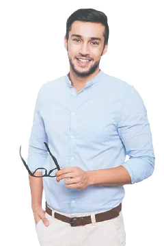 A smiling man in a light blue shirt holding a pair of glasses